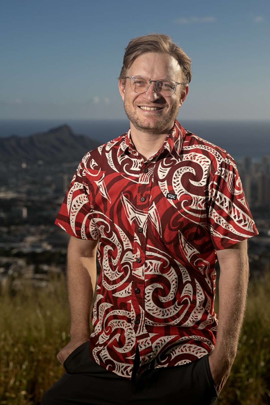 Steven Bond-Smith standing on a hillside above Honolulu, with Diamond Head and the ocean behind him